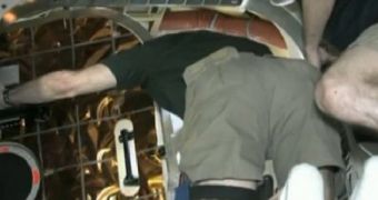 NASA astronaut Don Pettit opens the hatch to the Dragon capsule, on May 26, 2012