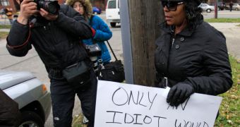 Driver Holds Up Idiot Sign, Her Punishment for Driving on the Sidewalk