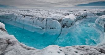 Researchers say Greenland's ice shelf is melting faster than expected due to sand particles embedded in it