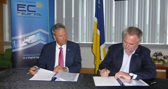 Eugene Kaspersky signs for his company offering expertise, threat data and trends to Europol