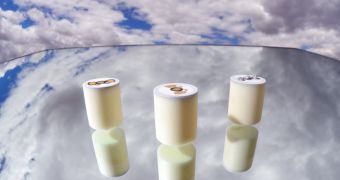 Sandia earplug-sized samplers, with silvery microvalves and solder connectors, seemingly hang poised to sample gases relevant to climate and weather