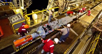 JOIDES Resolution crew members prep a CORK for installation beneath the seafloor