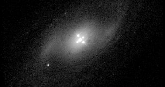 The cross mirage in the middle is a quasar magnified by the closer galaxy which appears to be around it