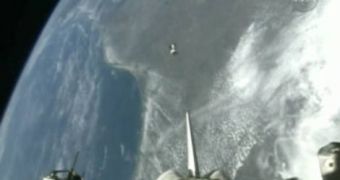 Endeavor jettisons small observation satellites from its cargo bay, while en route back to Earth
