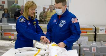 STS-130 Mission Specialists Kathryn Hire and Nicholas Patrick examine the replacement high-pressure ammonia jumper hoses that will fly on their mission