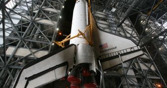The space shuttle Endeavor is seen here hoisted inside the VAB, before being mated with its fuel tank and auxiliary rockets atop of the mobile launch platform