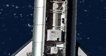 A test AMS device is seen here flying in space aboard space shuttle Discovery, during the STS-91 mission (1998)