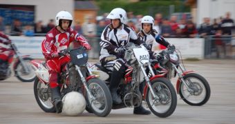 Motoball players attempt to get the ball into the net while riding bikes