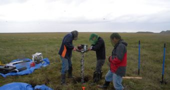 Scientists working with the NOAA-funded Cooperative Institute for Research in Environmental Sciences (CIRES) drill a permafrost core sample on the North Slope of Alaska near Deadhorse
