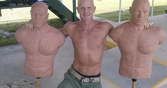Shirtless FBI agent Frederick W. Humphries poses with target dummies