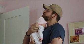 Bradley Cooper holds his fake plastic newborn daughter in "American Sniper"