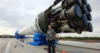 SpaceX CEO Elon Musk, co-founder of PayPal, stands next to the Falcon 9 rocket at the CCAFS