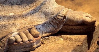 Ancient sculptures stand tall on platform sandals