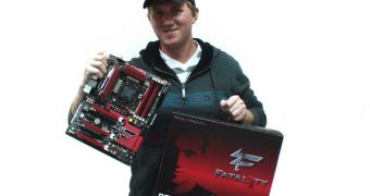Jonathan "Fatal1ty" Wendel holding the ASRock Intel P67 Fatal1ty Motherboard