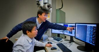 Staff scientist Gang Ren (standing) and postdoc colleague Lei Zhang checking images of individual proteins from their cryo-electron microscope at Berkeley Lab's Molecular Foundry
