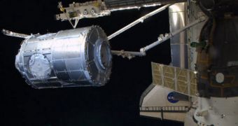 Tranquility being moved out of shuttle Endeavor's cargo bay via the station's robotic arm