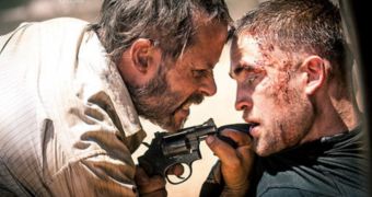 Guy Pearce and Robert Pattinson come to blows in first official still from “The Rover”