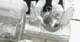 Garrett Reisman and Stephen Bowen, both STS-132 mission specialists, step out of the ISS Quest airlock at the beginning of their first spacewalk