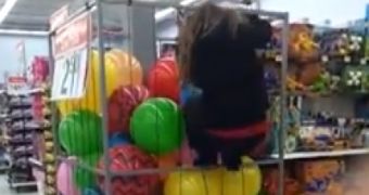 A teenage girl climbs inside a ball rack at Walmart