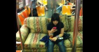 Ty sits on her couch on the train
