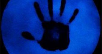 TNT contaminated handprint appears dark under ultraviolet light