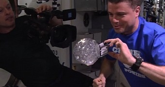 Astronaut inserting GoPro camera in bubble