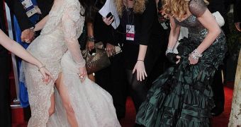 Madonna steps on Jessica Biel's dress on the red carpet at the Golden Globes 2012