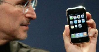 STeve Jobs holding the iPhone
