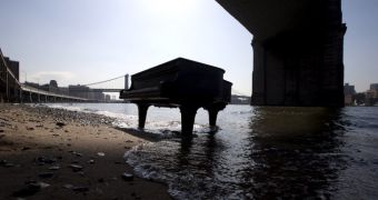Grand piano sits under the Brooklyn Bridge