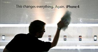 Apple employee washing a store's glass walls