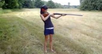 Girl falls as she fires a rifle