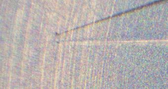 This magnified photo shows a tiny dust spec that Hayabusa collected from 25143 Itokawa
