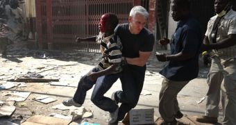 CNN correspondent Anderson Cooper helps an injured boy get to safety in Haiti