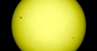 The massive sunspot AR1476 is visible to the top left of the image