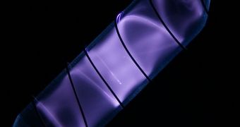 A photo showing pure hydrogen glowing in a vial