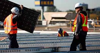 Workers installing solar panels for IKEA