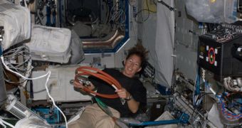 Sandra Magnus, conducting scientific experiments in the microgravity environment of the International Space Station