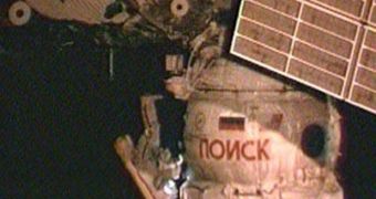Oleg Kotov is seen here working to activate the Poisk module's docking systems