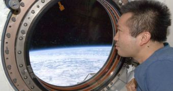 Wakata looking through one of ISS' viewports at our planet