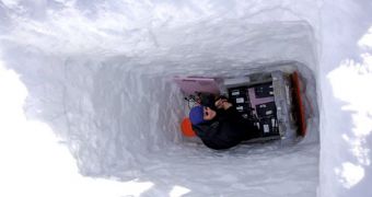 UAF glaciologist Martin Truffer is seen here installing seismic monitoring equipment deep in the ices of Bering Glacier