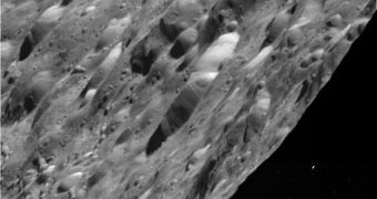 This Cassini image of Rhea shows craters in an area between day and night on the icy moon