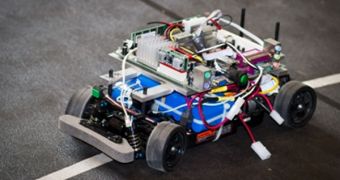 The researchers test their algorithm using a miniature autonomous vehicle traveling along a track that partially overlaps with a second track for a human-controlled vehicle