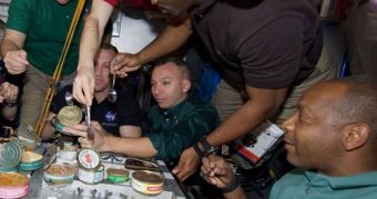 Astronauts from the ISS and Atlantis sharing a meal while they were all still aboard the station