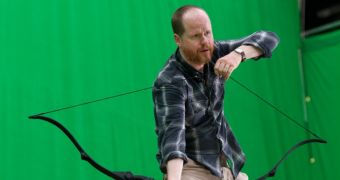 Joss Whedon toys with Hawkeye’s bow on “The Avengers” set