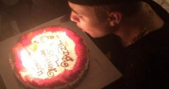 Justin Bieber blows out the candles on his 20th birthday as he also hits 50 million followers on Twitter