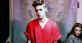 Justin Bieber is again in trouble with the law for allegedly punching a paparazzo and breaking his camera