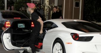 Justin Bieber gets out of his white Ferrari