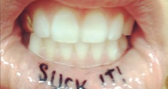 Ke$ha shows off her new tattoo, on the inside of her lip