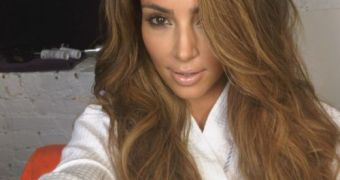 Kim Kardashian Launches Swimsuit Line, Goes Barbarella Blonde