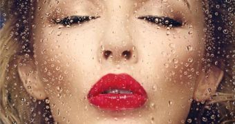 Kylie Minogue moves in for a kiss on the album cover of "Kiss Me Once"